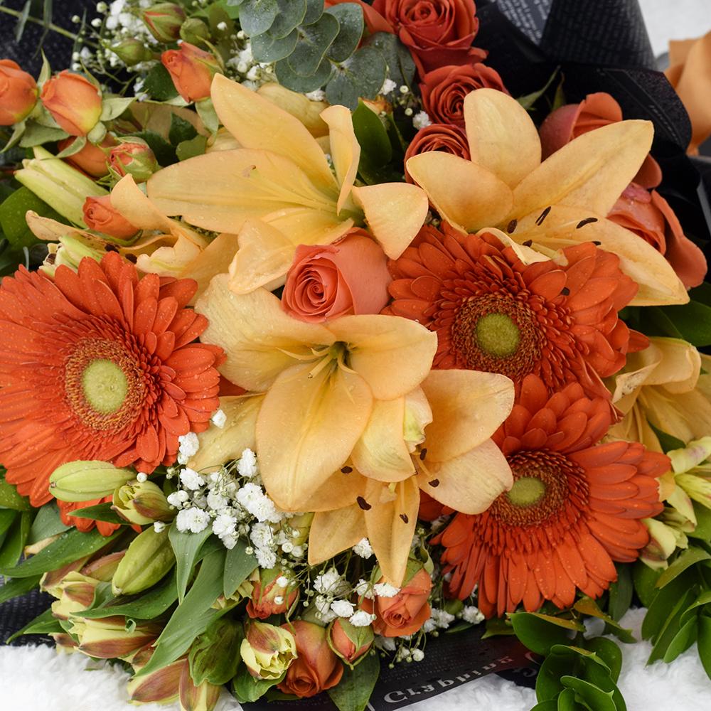 Beyond Brilliant Mixed Floral Bouquet Gift Set. Bottle of Red Wine, Roses, Lilies, Alstroemeria, and Gerbera Along with Baby’s Breath, Eucalyptus and Ruscus Gathered in a Floral Wrap and Tied with a Designer Ribbon. Mixed Floral Gifts from Heart & Thorn USA - Same Day USA Delivery.