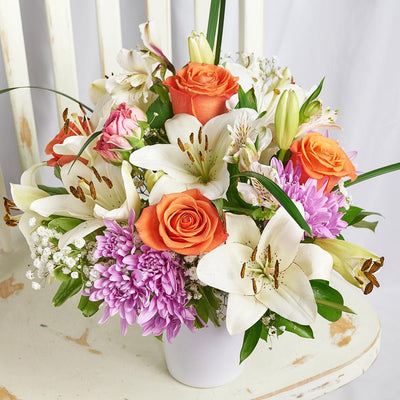 Heavenly Scents Flowers & Candle Gift. Roses, Daisies, Lilies, Alstroemeria, and Greens in a Ceramic Vessel, Paired with a Soothing Lavender-Scented Candle. Mixed Floral Gifts from Heart & Thorn USA - Same Day USA Delivery.