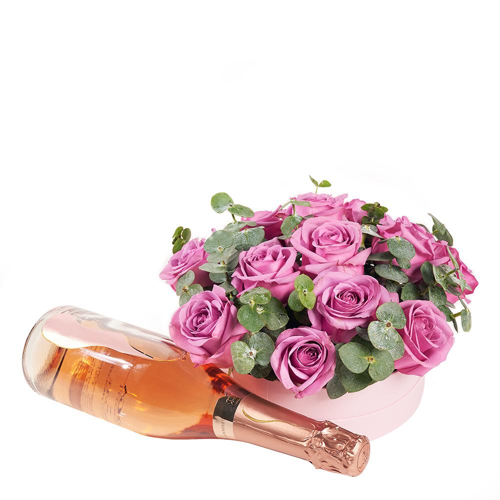 Luxe Passion Flowers & Champagne Gift. Pink Roses and Eucalyptus in a Round Pink Hat Box, with a Bottle of Sparkling Wine. Flower Gifts from Heart & Thorn USA - Same Day USA Delivery.