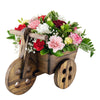 Sweet Talk Floral Gift Set. Multi-Colored Carnations, Baby’s Breath, and Greens in a Charming Wooden Cart Planter, with a Bottle of Red Wine. Floral Gifts from Heart & Thorn USA - Same Day USA Delivery.