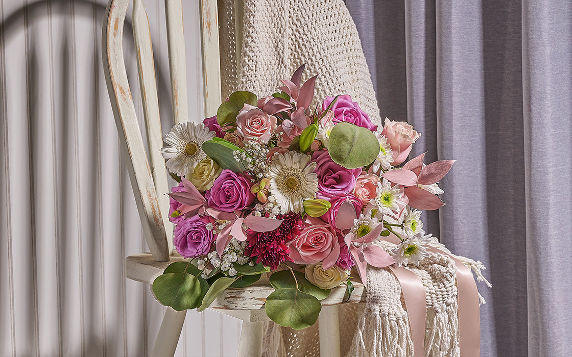Bouquet of flowers on a chair with a neutral background