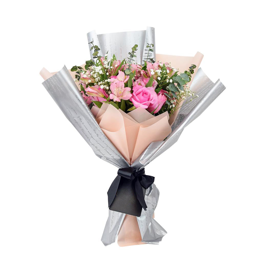Blushing Notes Mixed Rose Bouquet. Pink Roses and Other Filler Flowers and Leaves Beautifully Gathered Together with Designer Twine or Ribbons in a Floral Wrap. Mixed Flower Gifts from Heart & Thorn USA - Same Day USA Delivery.