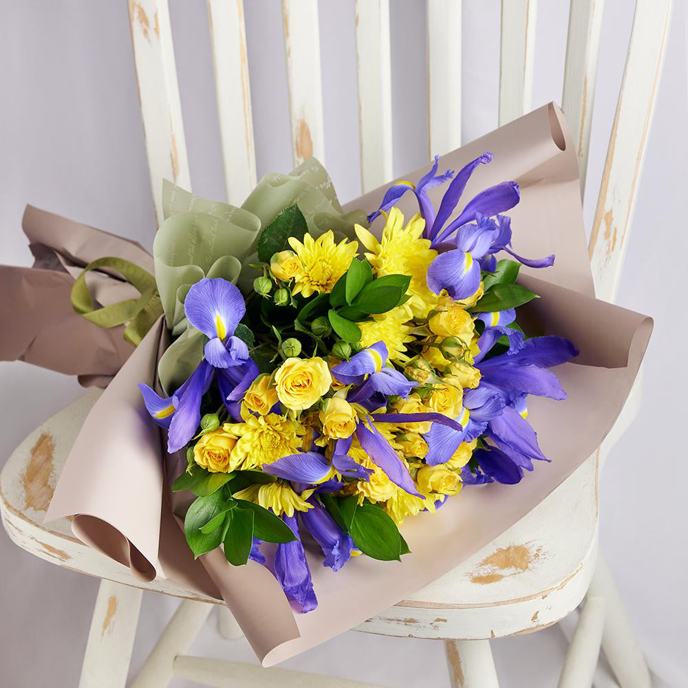 Luminous Lavender Iris Bouquet. Purple Irises and Yellow Spray Roses, Daisies, and Greens Gathered in a Floral Wrap and Tied with a Designer Ribbon. Mixed Floral Gifts from Heart & Thorn USA - Same Day USA Delivery.