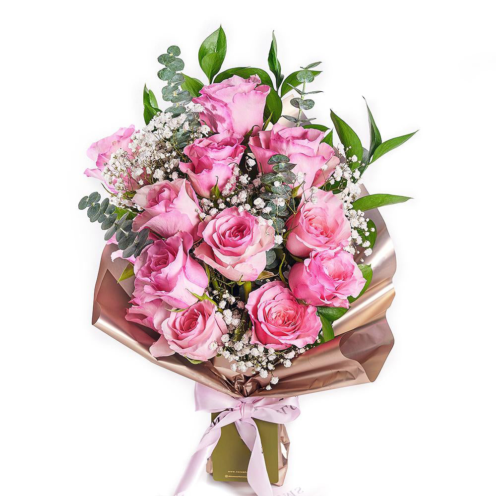 Mother's Day 12 Stem Prink Rose Bouquet. Dozen Pink Roses with Baby’s Breath and Greens in a Floral Wrap and Tied with Designer Ribbon. Flower Gifts from Heart & Thorn USA - Same Day USA Delivery.